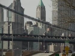 A reveal of traffic speeds down the FDR Highway in New York City the Manhattan Bridge and the Downtown Skyline are featured. Stock Footage