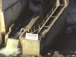 MS AERIAL DS PAN View of car moving on bridge near small dam at Howland / Maine, United States Stock Footage