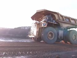 Medium Long Shot pan,left , A dump truck travels slowly through a strip mine. / West Virginia Stock Footage