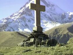 MS TU Shot of gergeti trinity church (tsminda sameba) with mount kazbegi and snowy peak, Georgia / Stepantsminda, Kazbegi, Georgia  Stock Footage