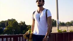 Man with longboard walking Stock Footage