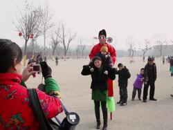 WS TD People taking group photo with folk artists on stilts at temple fair to celebrate Chinese spring festival / xi'an, shaanxi, china Stock Footage