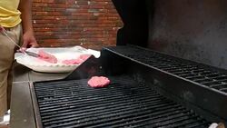 MS TS Man barbecuing for friends during backyard party Stock Footage