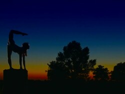 Acrobat girl exercising on column in the evening  Scorpio position Stock Footage