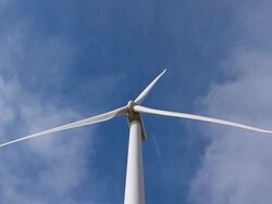 Wind Turbine With Jet Moving Overhead Stock Footage