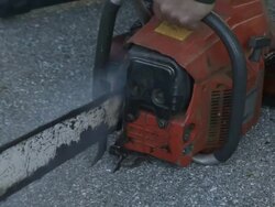 Medium hand-held - A logger starts a chainsaw. / California, USA Stock Footage