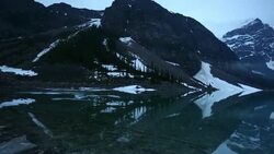 Track shot of Moraine Lake in early summer, Banff NP Stock Footage