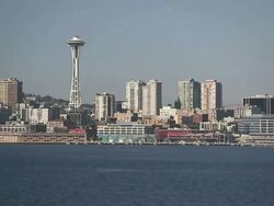 Wide Shot pan-left - The Space Needle overlooks Seattle's harbor / Seattle, Washington, USA Stock Footage