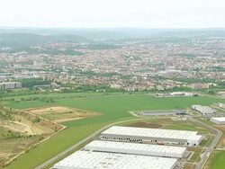 WS AERIAL View of greenfield with buildings / Brno, Brno City District, Czech Republic Stock Footage
