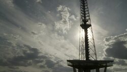 The sun shines through the clouds over a television antenna. Stock Footage