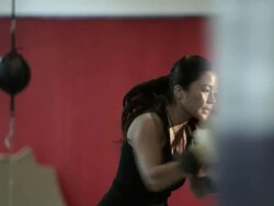 Female boxer using heavy bag Stock Footage