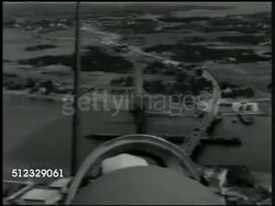 1942: U.S. AIRPLANE FLYING: AERIAL: (POV Co-pilot cockpit) Propellers of airplane flying over land, over bridge, back of pilot's head FG. World War II, WWII, Air Force, bombing run, air assault, Europe Instructional Video