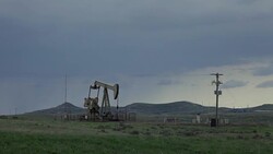 South Dakota stormy prairie oil pump jack flare stack pollution Stock Footage
