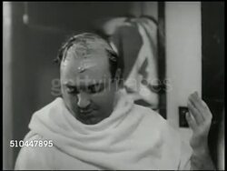 1950: DRAMATIZATION: Several empty bottle of hair tonic on shelf, same middle-aged man (30:45:18) w/ receding hairline coating hair w/ cream, messaging head, CU Same male w/ head full of hair, then taking toupee hairpiece off. Hair growth, pre-Rogaine Instructional Video