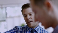 Shop owner chats with customer and talks him into buying shirt Stock Footage