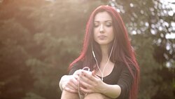 Young woman listening to music Stock Footage