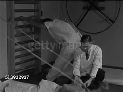 1946: RED CROSS: PHYSICAL THERAPY:  WS Rehabilitee victims in gym working out a variety of exercise, male physician observing. VS Male lying in bed, doing arm exercises, doing pull ups from bed, male physician supervising. Rehab, physiotherapy, PT Instructional Video