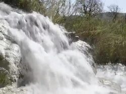 MS Shot of Sulphurous water plunges in waterfall in thermal pools / Saturnia, Tuscany, Italy Stock Footage