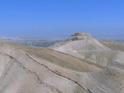 Aerial city of Jericho from over desert hills, Judea Desert, Israel Stock Footage