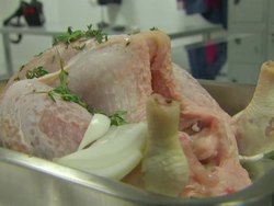 Raw chicken being prepared for roasting News Clip