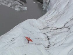 Extreme Long Shot aerial - A man carries a kayak across a huge expanse of ice on the ocean / Alaska, USA Stock Footage