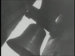 A large church bell rings in a bell tower. News Clip