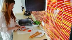 Pretty girl in her kitchen cutting vegetable ingredients. Stock Footage