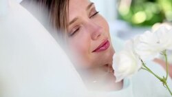 Woman holding and smelling white roses Stock Footage