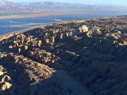 AERIAL TS WS  View of Low ride towards north of dead sea salt formations / Sourn Judea Desert, Israel  Stock Footage