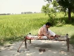 Farmer working on a laptop with his children playing  Stock Footage