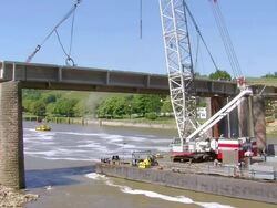 WS Crane ready to lifting up segment of deconstruction of bridge over river Mosel / Wellen, Rhineland Palatinate, Germany Stock Footage