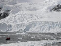 WS View of eco-tourists in zodiac near snowcapped mountain / Neko Harbor, Antarctica Stock Footage