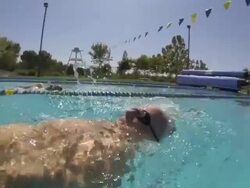 CU Side POV SLO MO Shot of male, baby boomer, swimming backstroke / Davis, California, United States  Stock Footage
