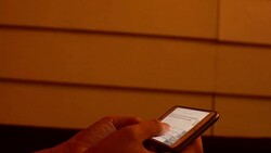 young woman using smart phone on the bed Stock Footage