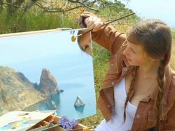 woman artist draws on the coast Stock Footage