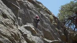 A rock climber falling and being saved by his rope. - Slow Motion Stock Footage
