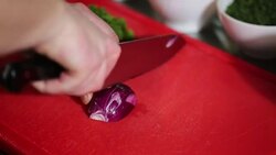 Chopping red onions on board Stock Footage