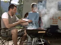 HD Super Slow-Mo: Father And Son Grilling Meat On Barbecue Stock Footage