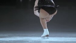 SLO MO Female figure skater in a sit spin variation Stock Footage