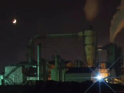 MS T/L Shot of moon moving over Lunar Eclipse of Bukseongpogu factory at night / Incheon, South Korea Stock Footage