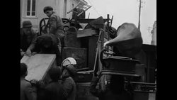 People loading trucks with household possessions during eruption of Mt. Vesuvius during World War II News Clip