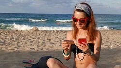 Woman on a vacation shopping online with credit card Stock Footage