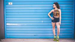 Fashion woman with roller skates posing over blue background Stock Footage