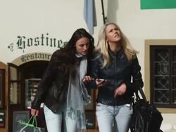 two women on a city street looking at an phone to get directions Stock Footage