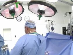 Doctors in operating room performing surgery Stock Footage