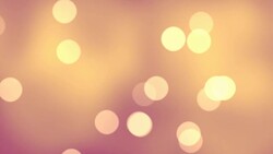 Floating loopable particles with a blurred light behind in FullHD. Stock Footage