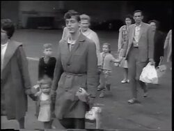 B/W 1961 East German refugees walking past camera / beginning of Berlin Wall / West Germany Stock Footage