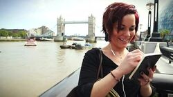 Tourist woman by the Tower Bridge in London Stock Footage