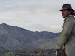 Man in trench coat turns around then get shot by cowboy behind him. Stock Footage