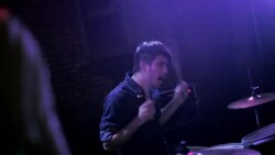 Rack focus from wide shot of drummer to close up of guitar Stock Footage